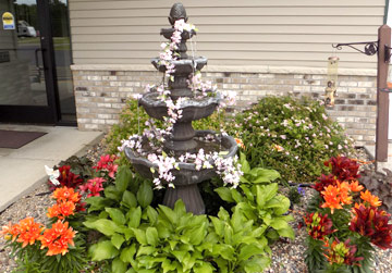Fountain in a flower garden | Respite Services